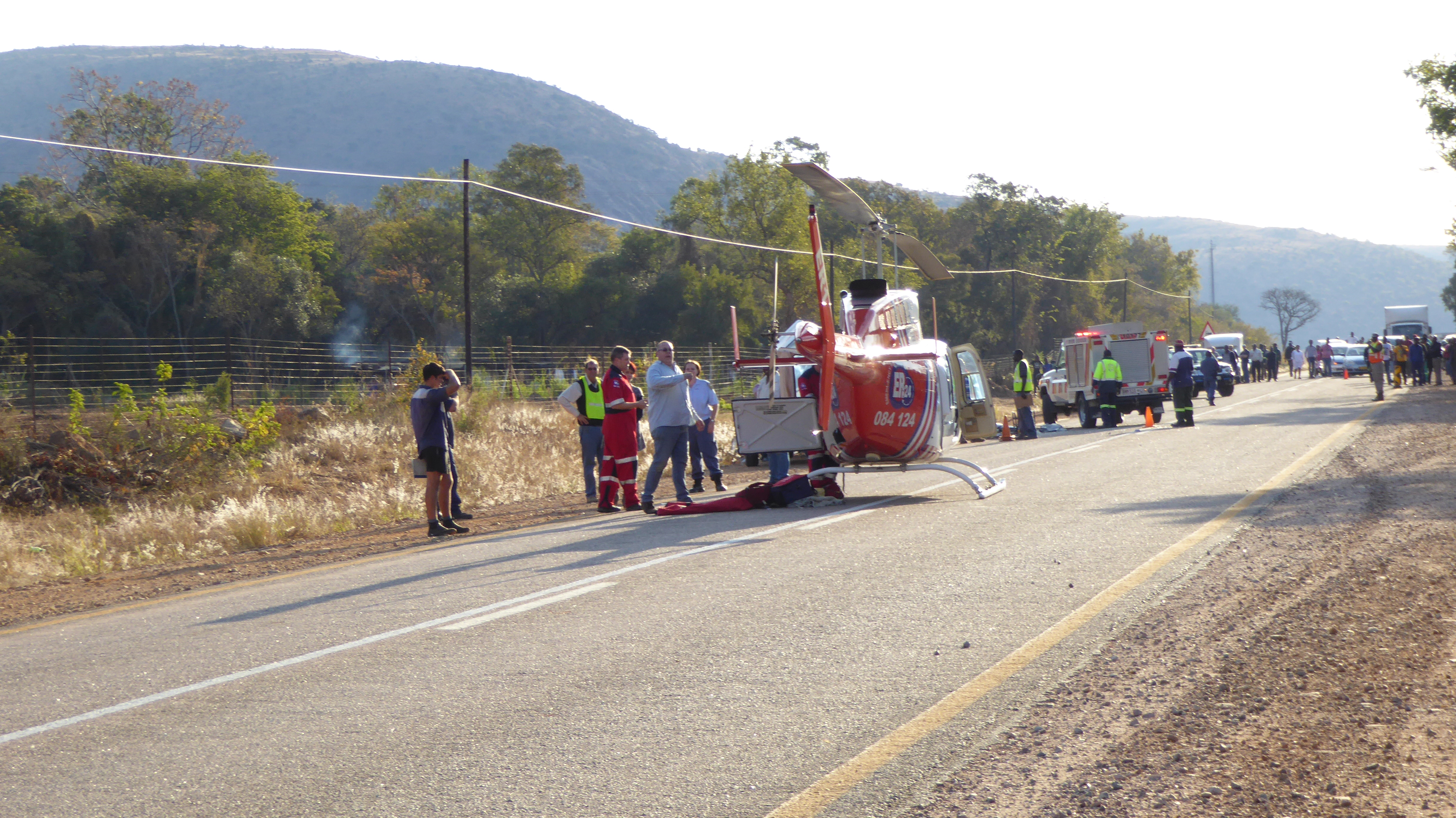 Helicopter evacuates the injured, after landing on the highway.