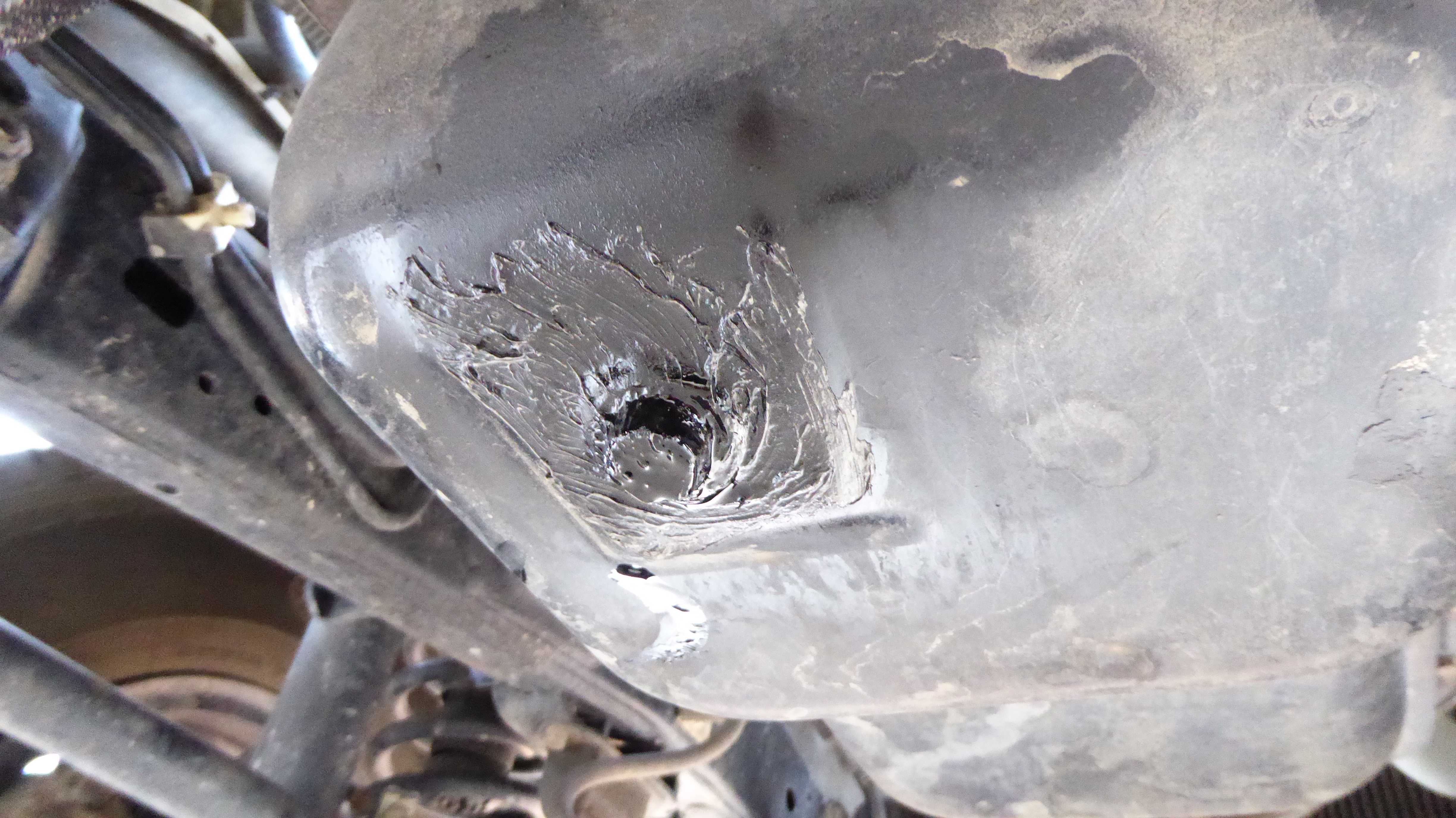 Source of oil leak: And oil drain plug, sealed with silicone. This is not a Toyota approved method of repairing a leaking oil plug. 