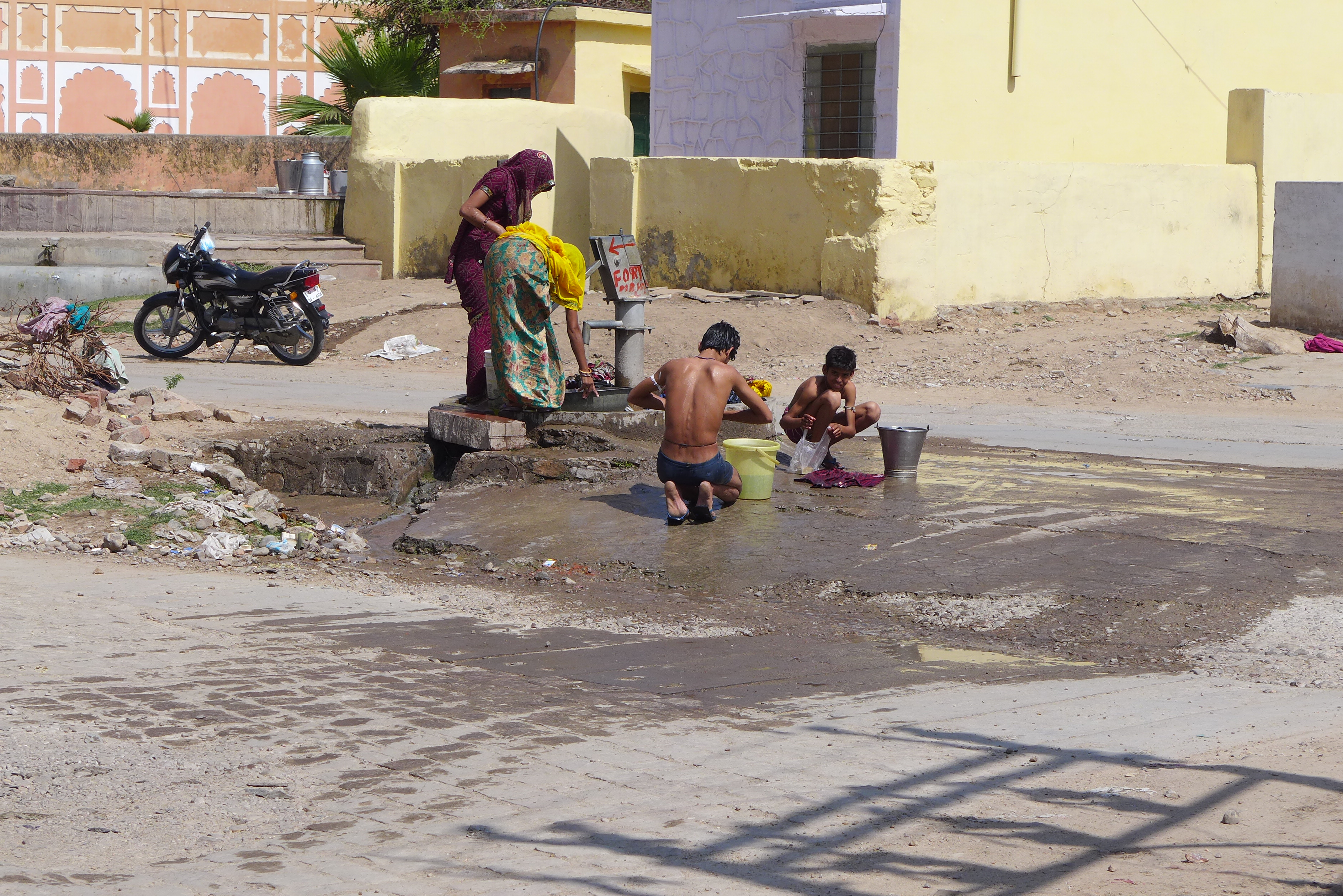 Boys bathing on the street in Amer. 