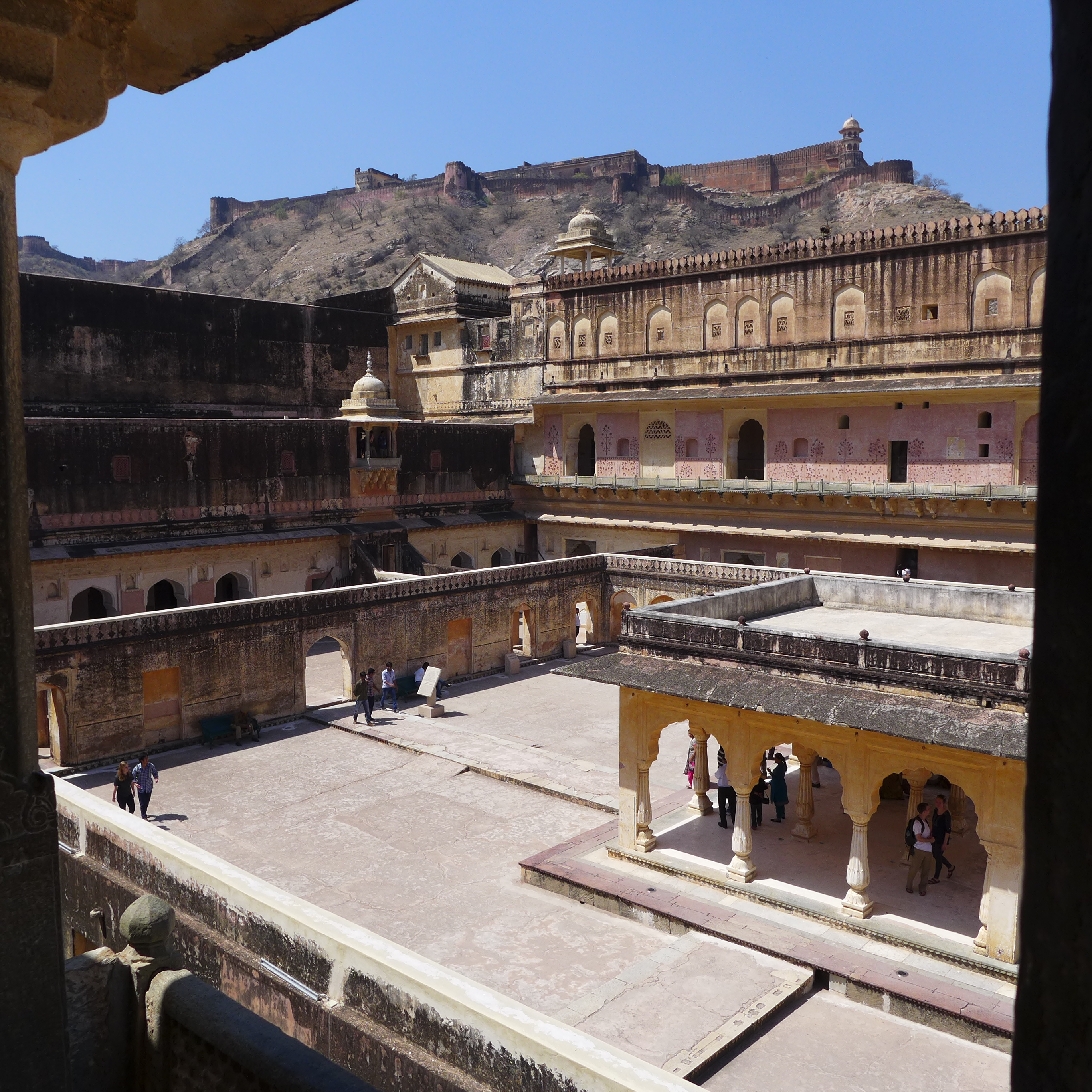 Courtyard with Palace of Man Singh1, and seen on the hilltop is the Jaigarh Fort.